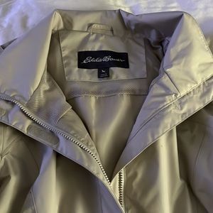 Woman’s water resistant zip and velcro rain jacket with foldable hood. Size L.